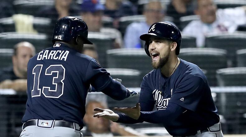 Ender Inciarte celebrates with Adonis Garcia after Garcia’s three-run homer that powered the Braves’ Tuesday win against the Mets. It was Inciarte who drove in the winning run Wednesday, then made the catch of the season for the Braves to rob Yoenis Cespedes of a would-be game-winning homer for the final out of a 4-3 win that gave the Braves a sweep of the Mets. (Getty Images)