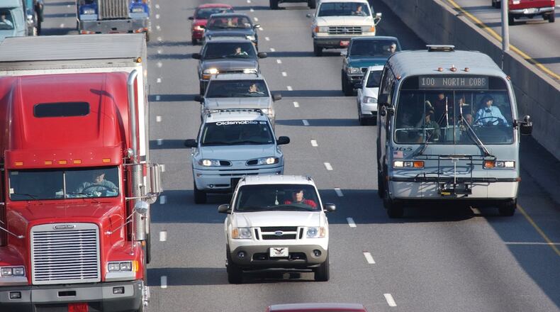 A Cobb County bus makes its way along I-75. (AJC 2002 file photo / Andy Sharp)