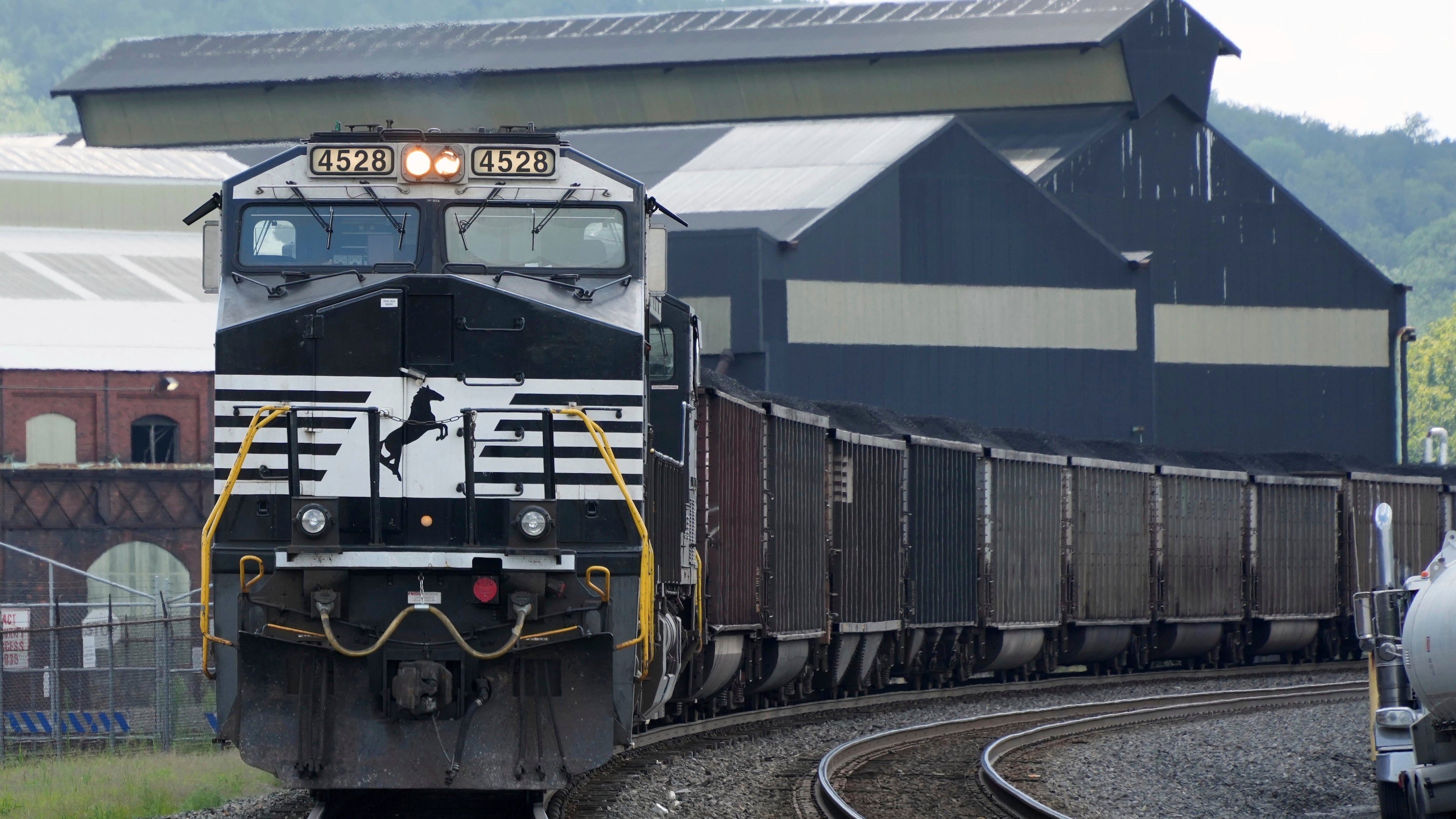 A Norfolk Southern freight train rolls past the U.S. Steel's Clairton Coke Works on Tuesday, Aug. 12, 2025, in Clairton, Pa. Union Pacific plans to acquire Atlanta’s Norfolk Southern for $85 billion. (Gene J. Puskar/AP)