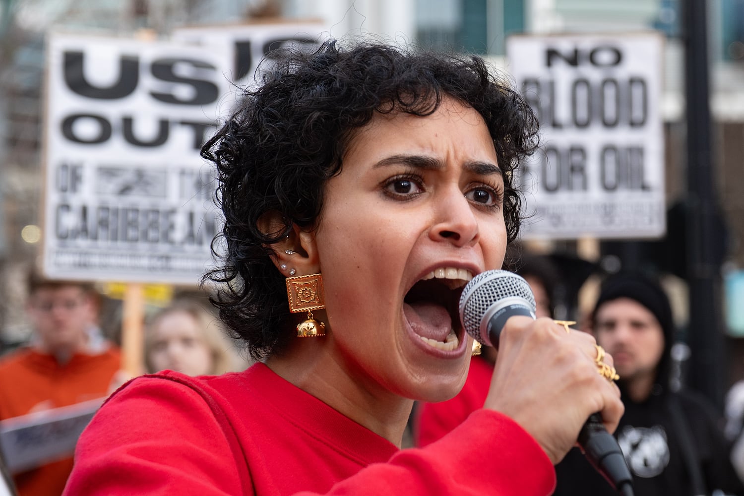 Iman Gadalla, with the Party for Socialism & Liberation, leads chants during a protest in downtown Atlanta on Saturday, Jan. 3, 2026, against the U.S. military action in Venezuela. (Ben Gray for the AJC)