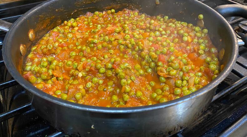 Piselli (braised peas in tomato sauce) from "Frugal Mediterranean Cooking" by Melanie Lionello (Page Street Publishing Co., 2020).
(Ligaya Figueras / ligaya.figueras@ajc.com)