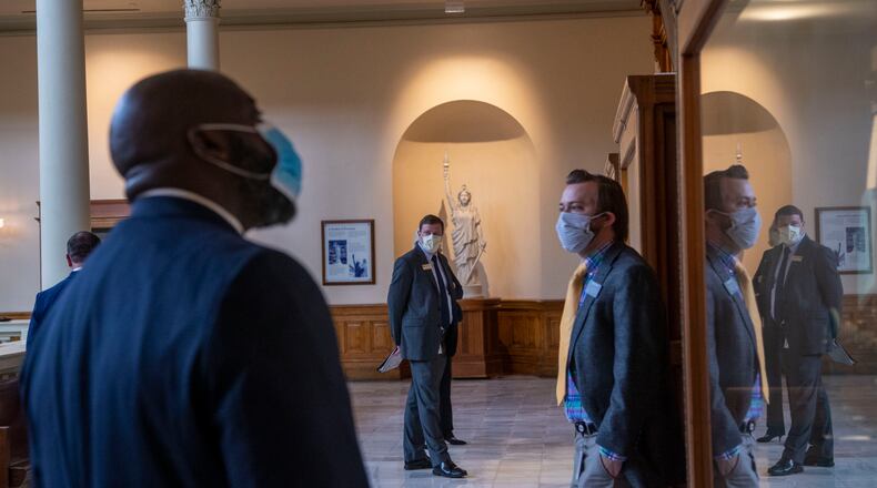 05/26/2020 - Atlanta, Georgia - Individuals wearing face masks wait to be called in to speak on budget cuts within the education sector of Georgia during a Senate appropriations education subcommittee meeting at the Georgia State Capitol building in Atlanta, Tuesday, May 26, 2020. This is the first semi-live committee hearing at the Capitol since March 16. (ALYSSA POINTER / ALYSSA.POINTER@AJC.COM)