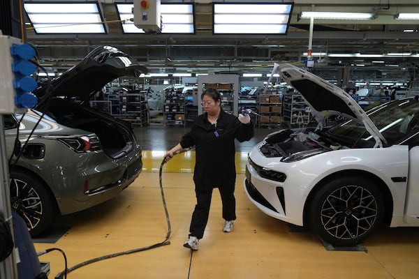 A worker checks coolant system on the Zeekr 001 EV models at the Chinese automaker Zeekr assembly plant, in Ningbo, east China's Zhejiang Province on April 16, 2025. (AP Photo/Andy Wong)