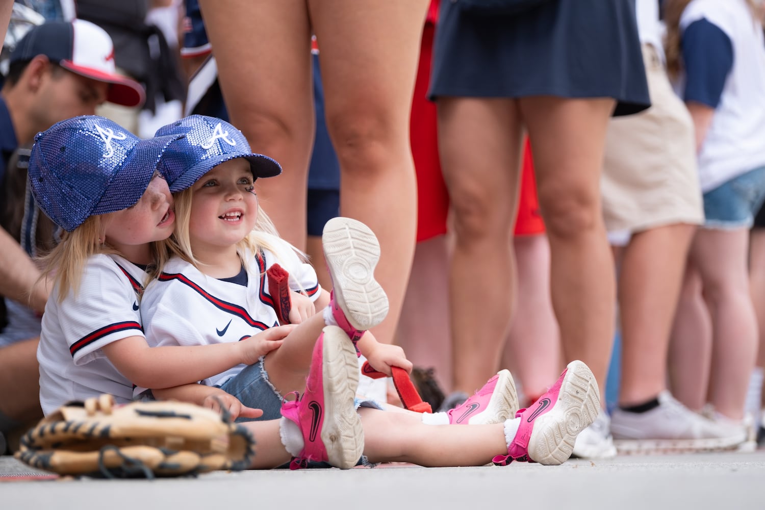 Brynlee Wood, 4, holds her sister Brielle, 3, as the pair wait for the start of the Braves Walk before the home opener Friday, April 4, 2025.   Ben Gray for the Atlanta Journal-Constitution