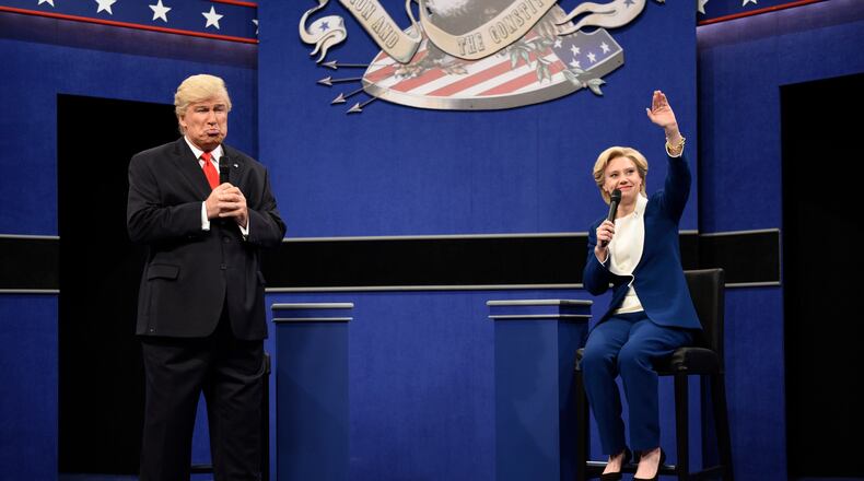 In this Oct. 15, 2016 photo provided by NBC, Alec Baldwin, left, as Republican presidential candidate, Donald Trump, and Kate McKinnon, as Democratic presidential candidate, Hillary Clinton, perform during the during the "Debate Cold Open" sketch. Republican presidential candidate Donald Trump tweeted early Sunday morning, Oct. 16 that the show’s skit depicting him this week was a “hit job.” Trump went on to write that it’s “time to retire” the show, calling it “boring and unfunny” and adding that Alec Baldwin’s portrayal of him “stinks.”(Will Heath/NBC via AP)