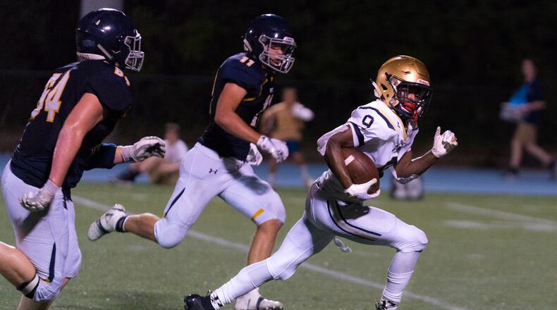 St. Pius running back Jason Jones (9) breaks free against the Marist defense in the second half of Friday's game. (Drew Dinwiddie/Special)