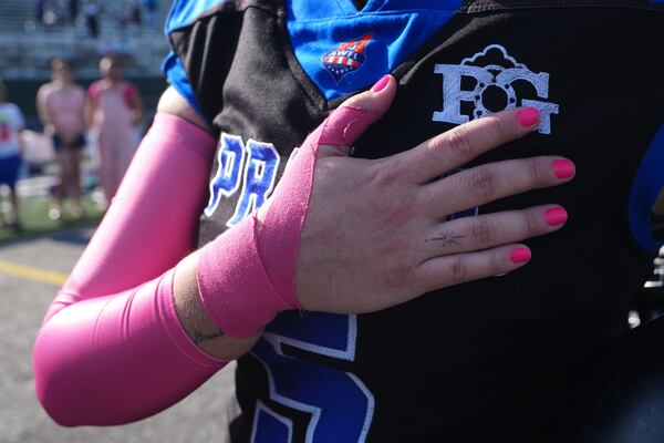 Detroit Prowl's Sydney Hebel holds her hand over her heart during the playing of the national anthem at the start of the AWFL women's football game against the Lansing Legacy, in Allen Park, Mich., Saturday, May 10, 2025. (AP Photo/Paul Sancya)