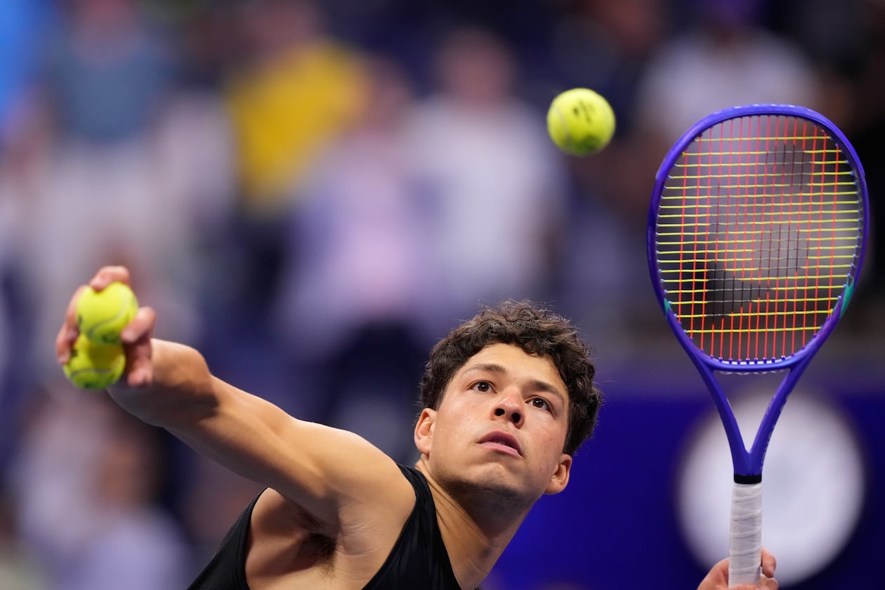 Ben Shelton, of the United States, hits balls to audience after he won his match against Frances Tiafoe, of the United States, during the men's singles semifinals of the U.S. Open tennis championships Friday, Sept. 11, 2026, in New York. (AP Photo/Yuki Iwamura)