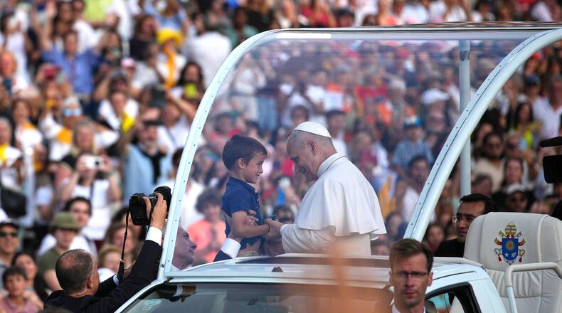 Pope Leo XIV blesses a child before a prayer vigil at Lluis Companys Olympic Stadium in Barcelona, Spain, Tuesday, June 9, 2026. (AP Photo/Emilio Morenatti)