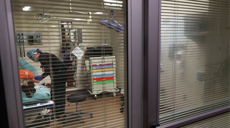 In this file photo, Carey Mullis, a registered nurse, works with a COVID-19 patient just after his arrival at the Colquitt Regional Medical Center. Curtis Compton /The Atlanta Journal-Constitution.
