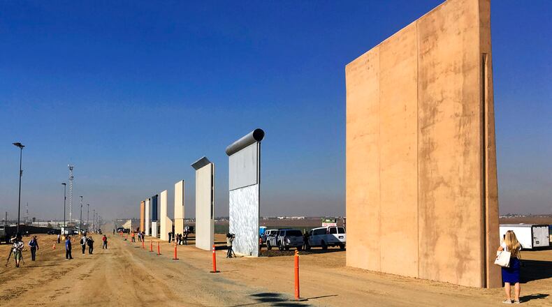 FILE - This Oct. 26, 2017, file photo shows prototypes of border walls in San Diego. President Donal Trump is heading to California on March 13, 2018, in his first visit to the state he loves to hate, since becoming president.  (AP Photo/Elliott Spagat, File)