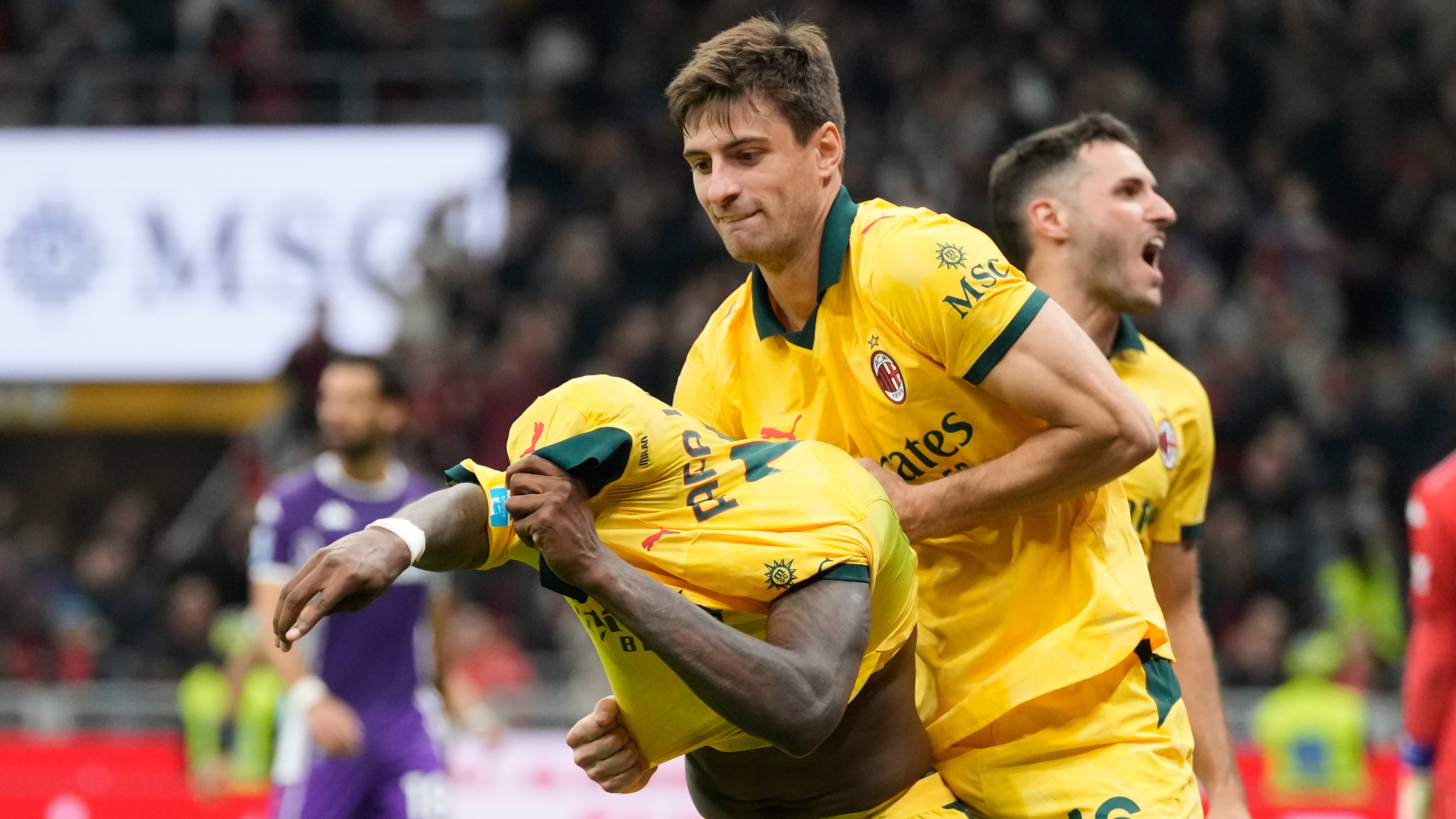 AC Milan's Rafael Leao, left, is congratulated after scoring his side's 2nd goal during a Serie A soccer match between AC Milan and Fiorentina in Milan, Italy, Sunday, Oct. 19, 2025. (AP Photo/Luca Bruno)