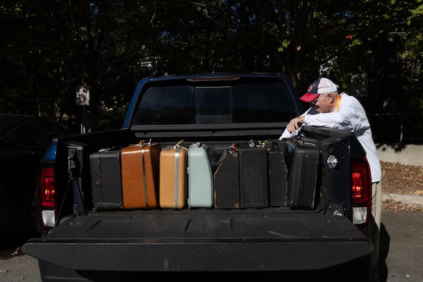 Tom Rehkopf, 82, unloads typewriters from his truck for a “typewriter petting zoo” event at Emory University’s Woodruff Library on October 22, 2025. Rehkopf has collected around 1,000 typewriters. (Arvin Temkar / AJC)