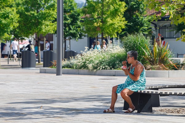 A woman eats an ice cream, Monday, June 30, 2025 in Saint-Jean-de-Luz, southwestern France. (AP Photo/Nicolas Mollo)