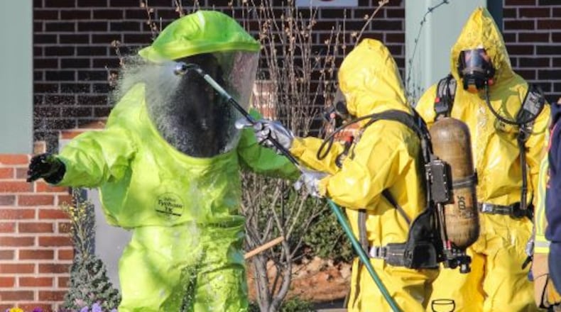 Atlanta Fire Rescue decontamination workers cleaned up Tuesday after responding to a chlorine leak. JOHN SPINK / JSPINK@AJC.COM