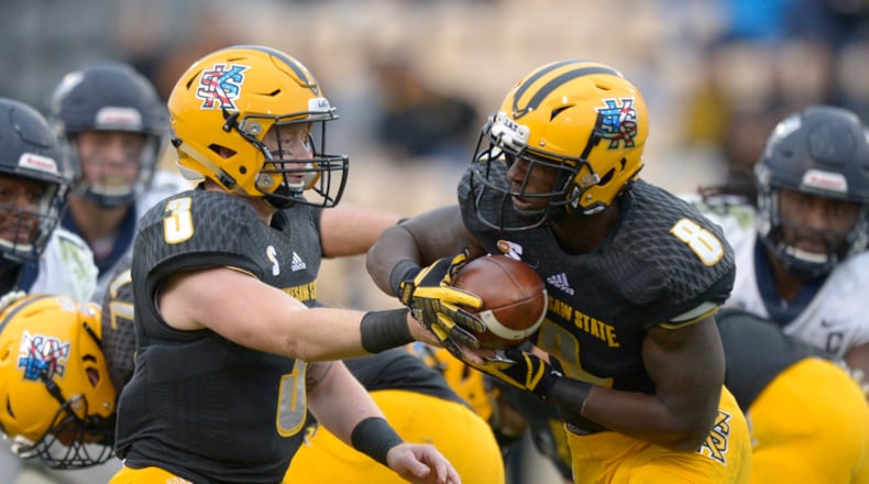Junior Chandler Burks (3) hands off to sophomore TJ Reed (8) in the first half of a game at Kennesaw Sate University's Fifth Third Bank Stadium Saturday, November 11, 2017. Special/Daniel Varnado