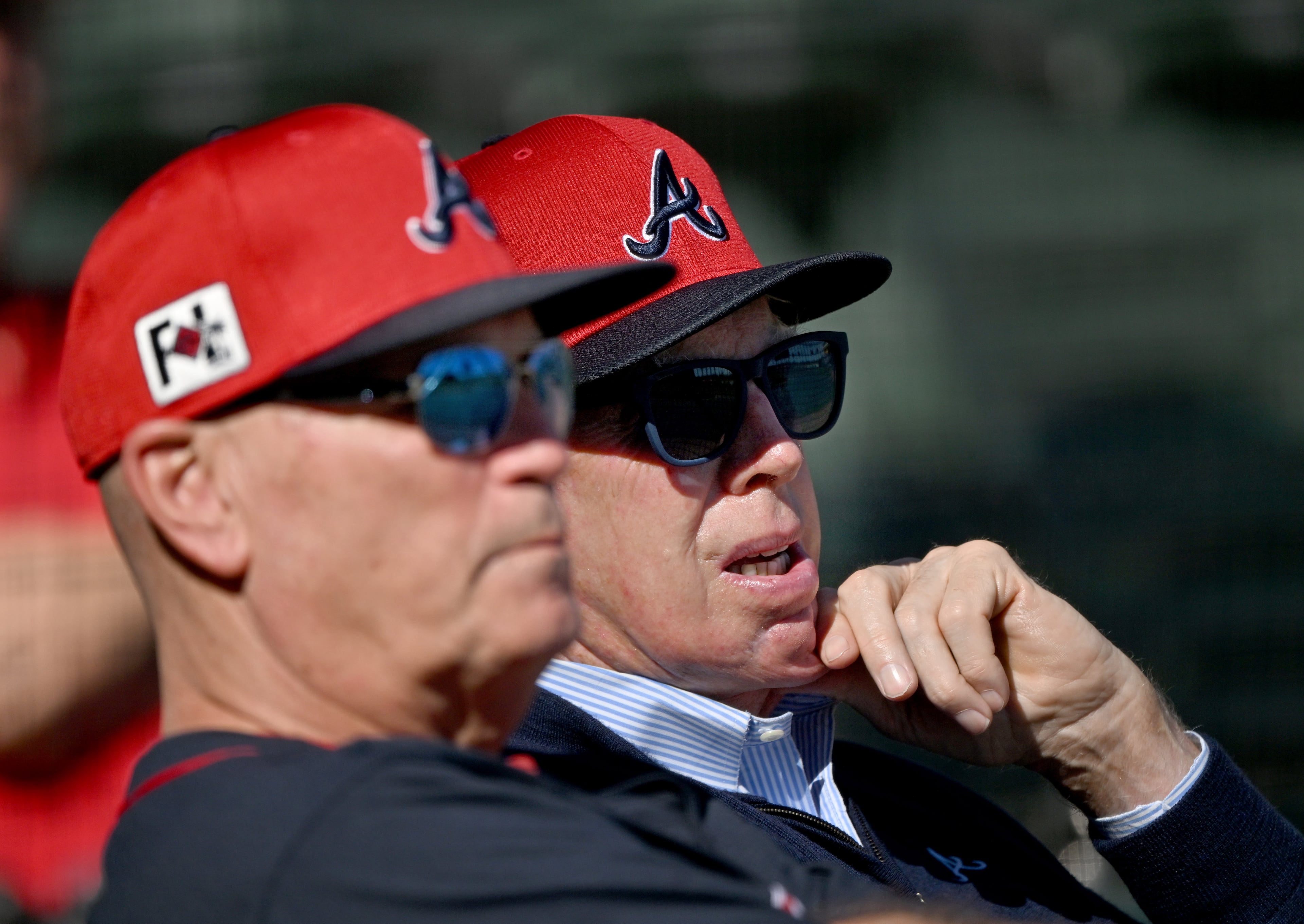 Terry McGuirk, left, chairman and CEO of Atlanta Braves Holdings Inc., chats with manager Brian Snitker during spring training.