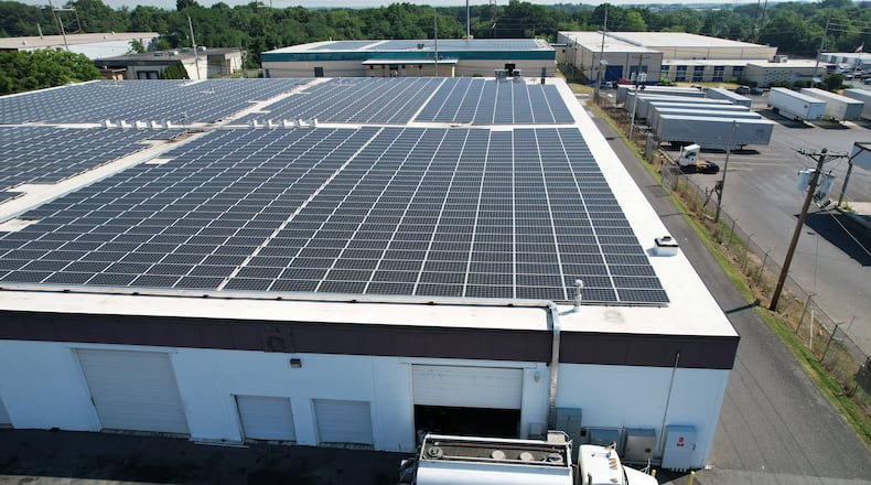 Solar arrays on top of a warehouse in Pennsauken, New Jersey, on June 13, 2024. The array was built by Solar Landscapes. The company installs solar as part of New Jersey's community solar program, in which the arrays create power that can be bought by people living nearby. (Jenna Miller/The Philadelphia Inquirer/TNS)