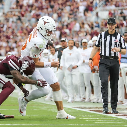 Texas quarterback Arch Manning, center right, runs out of bounds against Mississippi State safety Jahron Manning, center left, during the first half of an NCAA college football game in Starkville, Miss., Saturday, Oct. 25, 2025. (AP Photo/James Pugh)