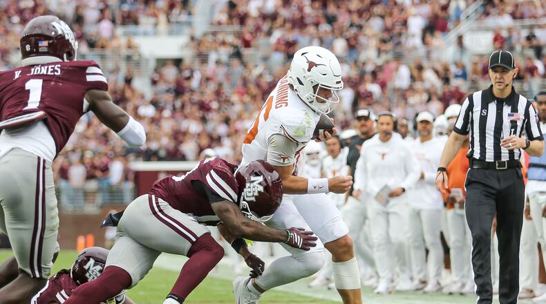 Texas quarterback Arch Manning, center right, runs out of bounds against Mississippi State safety Jahron Manning, center left, during the first half of an NCAA college football game in Starkville, Miss., Saturday, Oct. 25, 2025. (AP Photo/James Pugh)