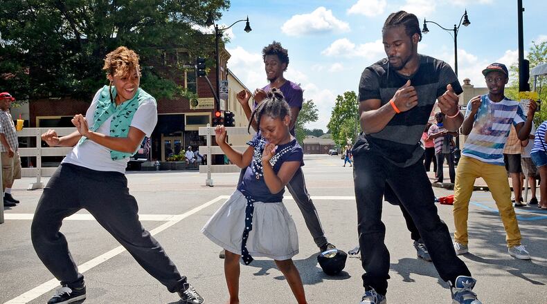 In this file photo, with a little background help from the dance performers UniqueSouls, Aniya Griffin, 8, of Marietta, puts on a fantastic and crowd-pleasing impromptu street dance show at the 11th Annual Juneteenth Cultural Festival in Glover Park on the Marietta square. (PHOTO M. CHRIS HUNT)