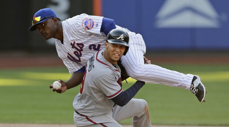 Andrelton Simmons, shown after a hard slide earlier this season, plays he game hard and has dealt with several injuries in his career. The Braves hope a thumb injury sustained Saturday is just a mild sprain. (AP Photo/Frank Franklin II)