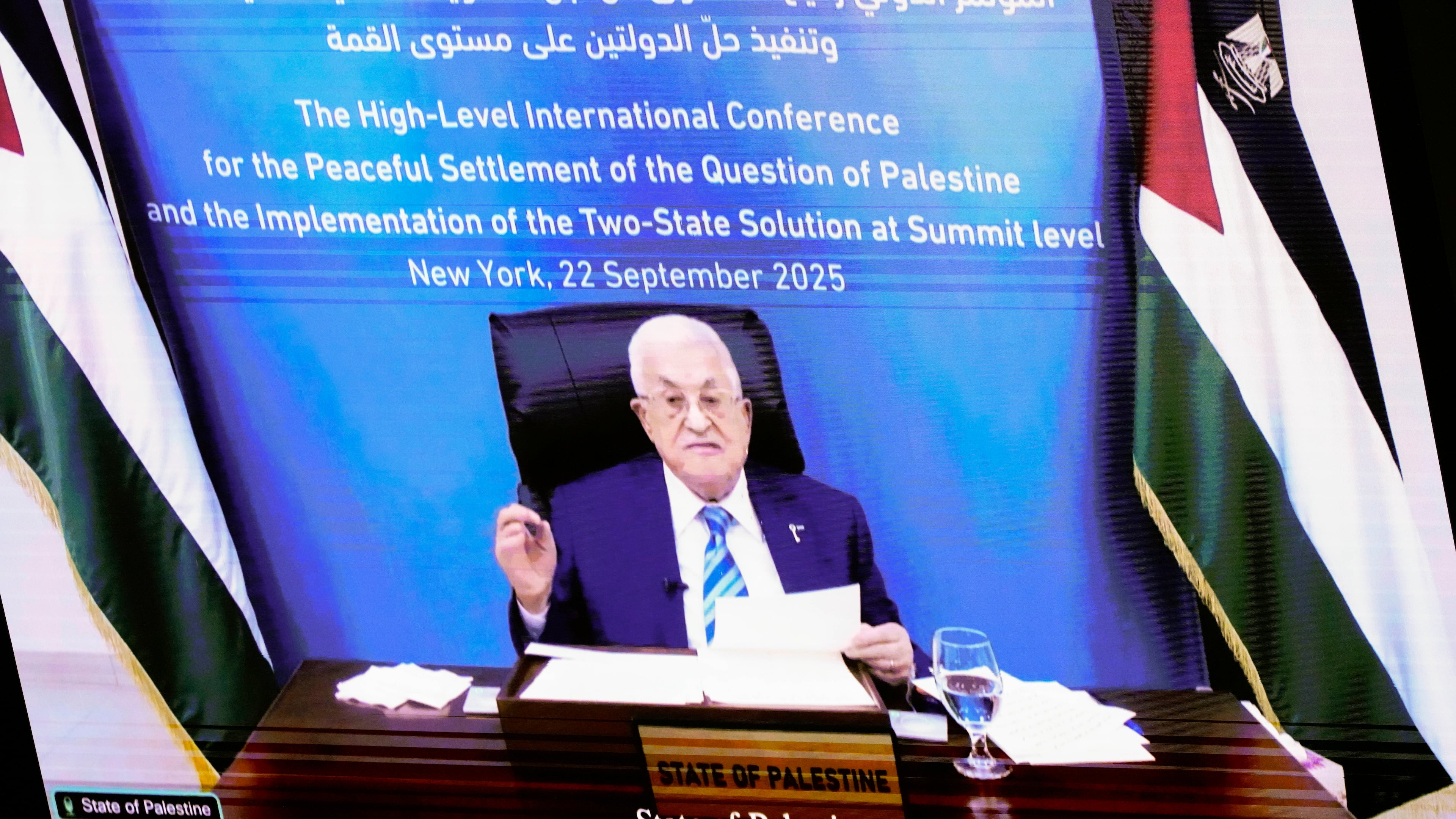 Palestinian President Mahmoud Abbas appears on a screen as he speaks virtually during a high-profile meeting at the United Nations aimed at galvanizing support for a two-state solution to the Israeli-Palestinian conflict Monday, Sept. 22, 2025, at UN headquarters (AP Photo/Yuki Iwamura)