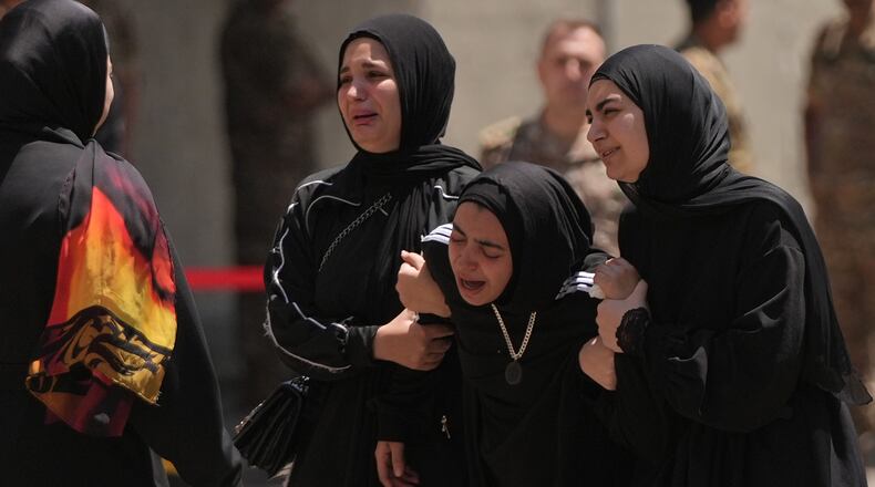 Relatives of the Lebanese soldier Hussein Nazzal, who was killed Saturday in south Lebanon along with a brigadier general and a captain in an Israeli airstrike, mourn during his funeral procession in Beirut, Sunday, June 7, 2026. (AP Photo/Hassan Ammar)
