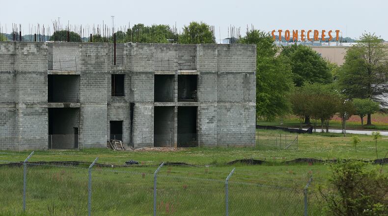 The cinderblock shell of a hotel that was supposed to be finished a decade ago sits a stone’s throw from Stonecrest Mall as a testament to the increasing vacancy of stores around the mall and the challenges facing suburban shopping centers on Wednesday, April 13, 2016. Curtis Compton / ccompton@ajc.com