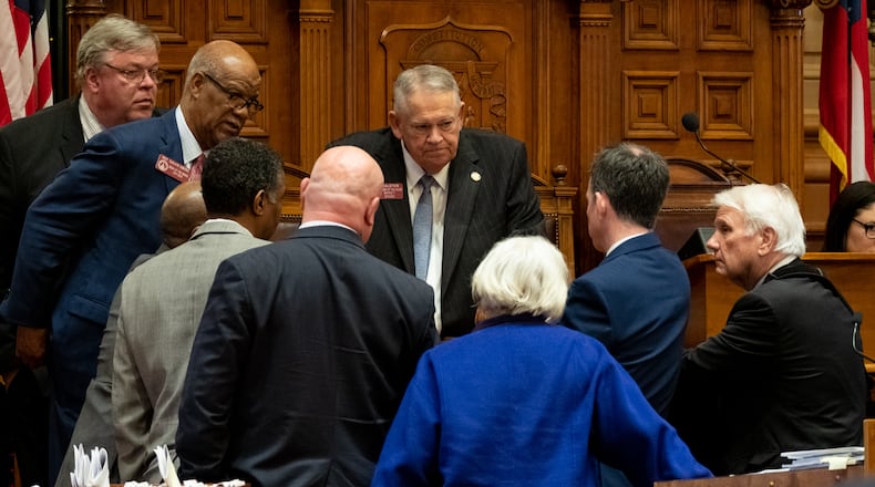 200312-Atlanta-Speaker of the House David Ralston huddles with representatives Thursday afternoon March 12, 2020 just before announcing that the Legislature would suspend the session on Friday due to the coronavirus. Ben@BenGray.com / Special