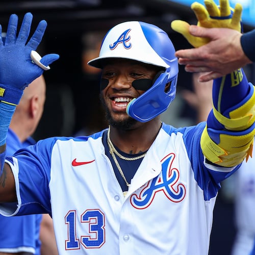 The Braves' Ronald Acuña Jr. (center) high-fives teammates after hitting a two-run home run Saturday against the Padres in Atlanta. (Colin Hubbard/AP)