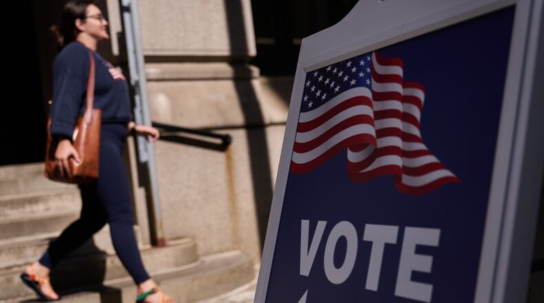 A sign directs voters to an entrance for City Hall during early voting for the Rhode Island primary election, Wednesday, Sept. 2, 2026, in Providence, R.I. (AP Photo/David Goldman)