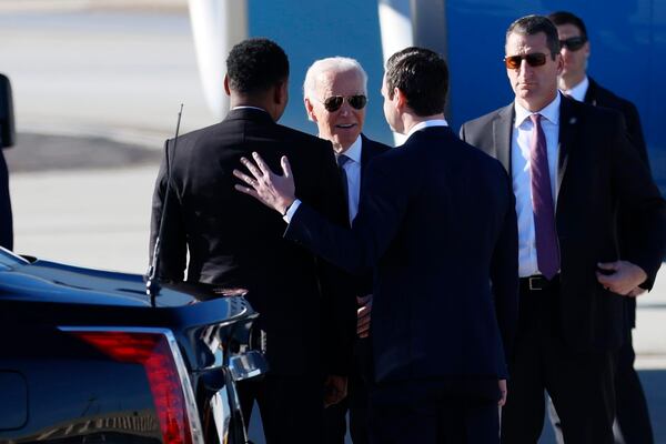 President Joe Biden speaks with U.S. Sen Jon Ossoff and Atlanta Mayor Andre Dickens as he arrives at Hartsfield-Jackson International Airport before delivering a sermon at Ebenezer Baptist Church on Sunday, January 15, 2023. (Photo: Miguel Martinez / miguel.martinezjimenez@ajc.com)