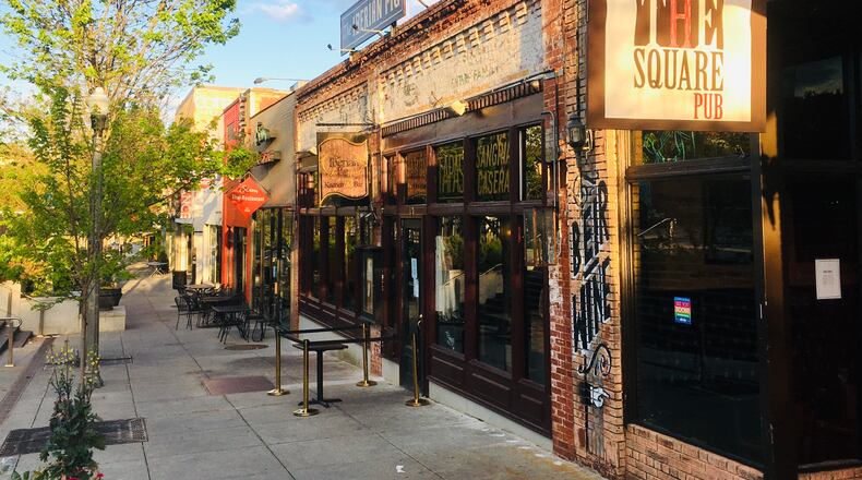 This sidewalk on the Decatur Square is usually packed with patrons during a normal weeknight, but the area’s turned into a virtual ghost town during the COVID-19 outbreak. The Square Pub (foreground), beloved by many, has closed for good, but that came shortly before the virus. Bill Banks for the AJC