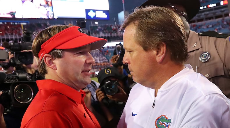 Georgia head coach Kirby Smart,left, and Florida head coach Jim McElwain meet at midfield after Georgia beat Florida 42-7 an NCAA college football game, Saturday, oct. 28,, 2017, in Jacksonville, Fla. (Curtis Compton/Atlanta Journal-Constitution via AP)
