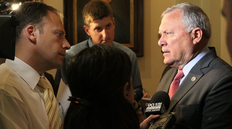 Gov. Nathan Deal talks to reporters Thursday about allegations that the head of the state ethics commission intervened on his behalf during an investigation.