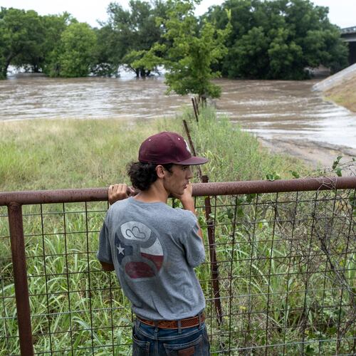 Hugh Ghormley watches as water moves along the Pedernales River at the Blanco County Fair and Rodeo on Thursday, July 16, 2026, in Johnson City, Texas. (AP Photo/Joel Angel Juarez)