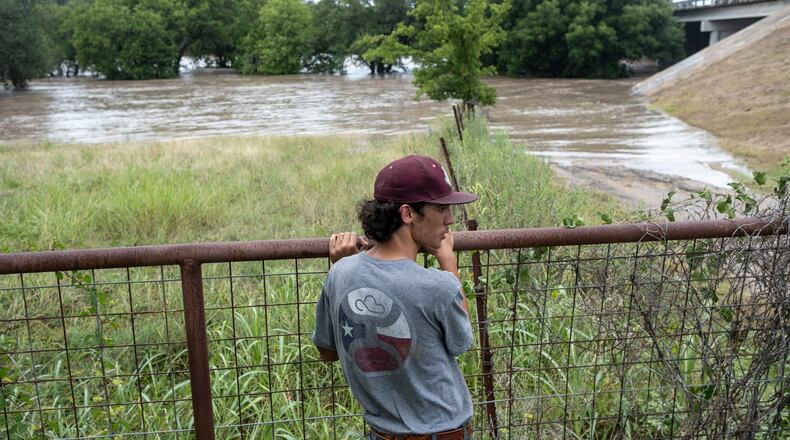 Hugh Ghormley watches as water moves along the Pedernales River at the Blanco County Fair and Rodeo on Thursday, July 16, 2026, in Johnson City, Texas. (AP Photo/Joel Angel Juarez)