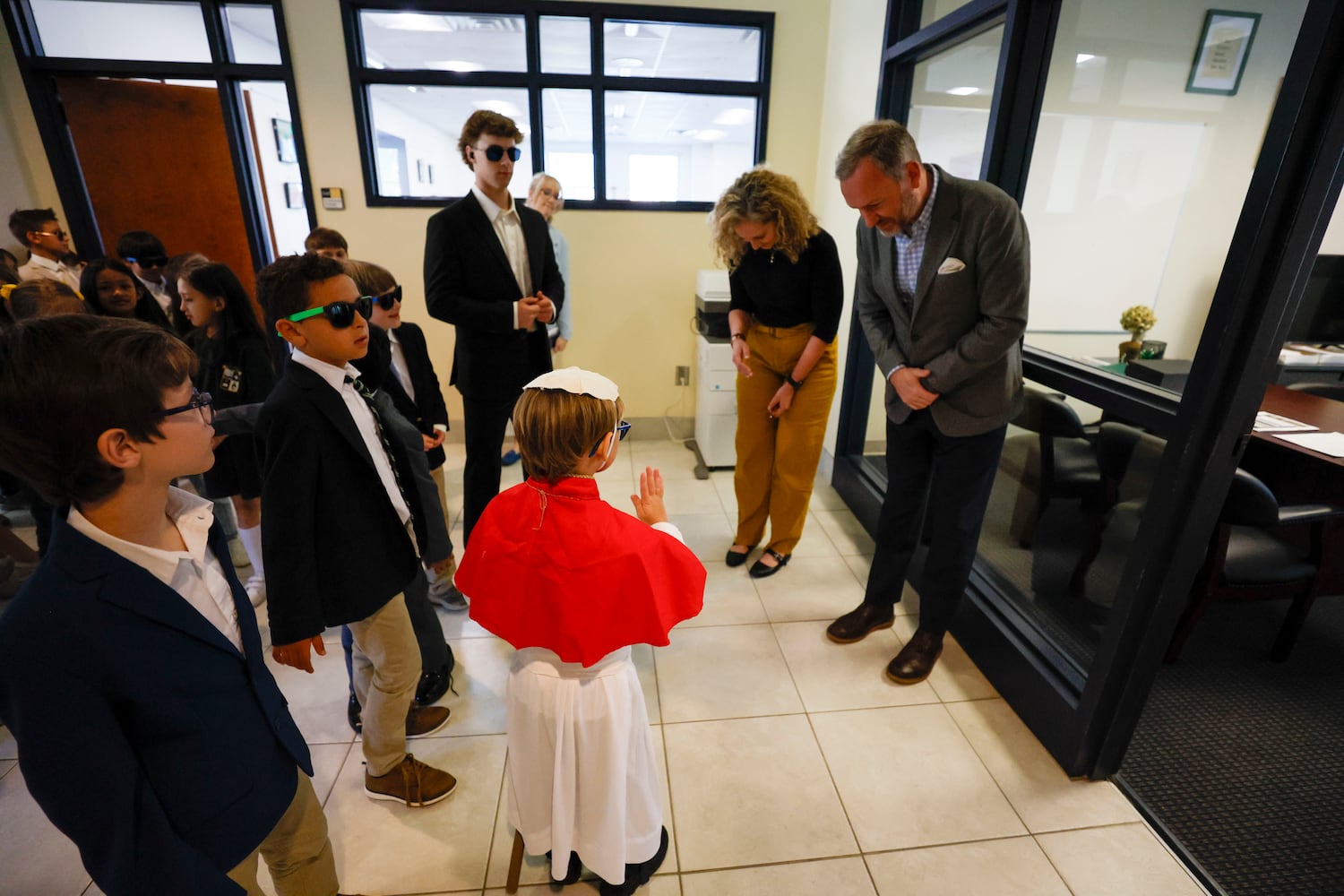 Second grader  David Levergood, who was elected as a pretend Pope, give his blessings while touring Pinecrest Academy. This event was part of a fun mock papal conclave, where students experienced what it might be like to choose a Pope on Tuesday, May 6, 2025.
(Miguel Martinez/ AJC)