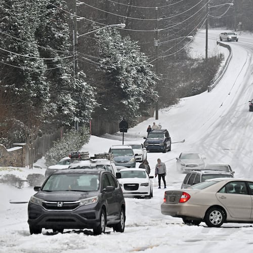 Vehicles get stuck in the snow on Old Snellville Highway on Friday, Jan. 10, 2025, in Lawrenceville. Georgia is bracing for a possibly significant winter storm expected this weekend. (Hyosub Shin/AJC)