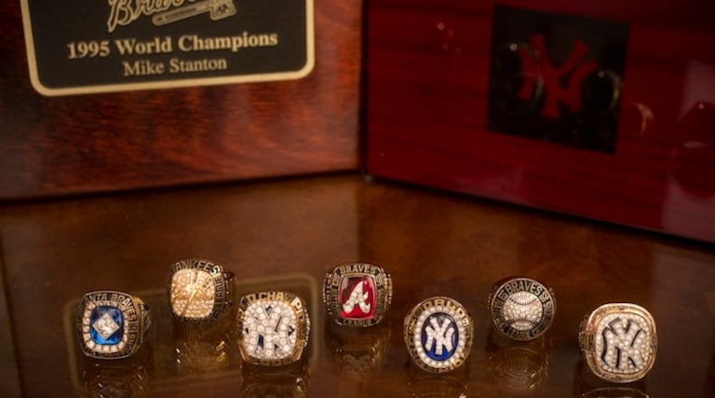 Former Major League Baseball pitcher Mike Stanton's seven championship rings from his years with the Atlanta Braves and New York Yankees: four World Series Champions rings in front and three American League Champions rings in back, in Montgomery, Texas, Nov. 24, 2015. It is unclear when the practice started, but Major League Baselball teams that lose the World Series often buy themselves rings for winning their league's pennant. (Michael Stravato/The New York Times)