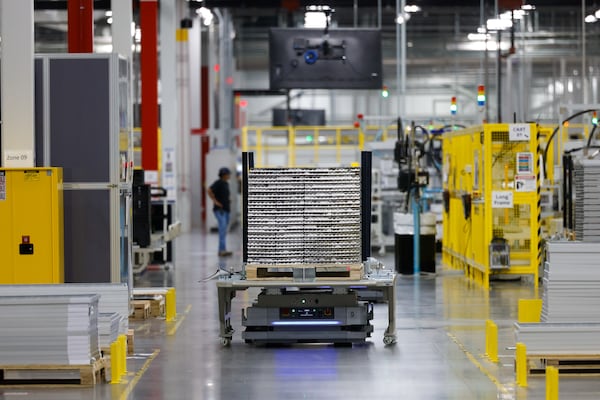 A machine carries solar panels at the Qcells solar factory in White on June 8, 2026. (Arvin Temkar/AJC)