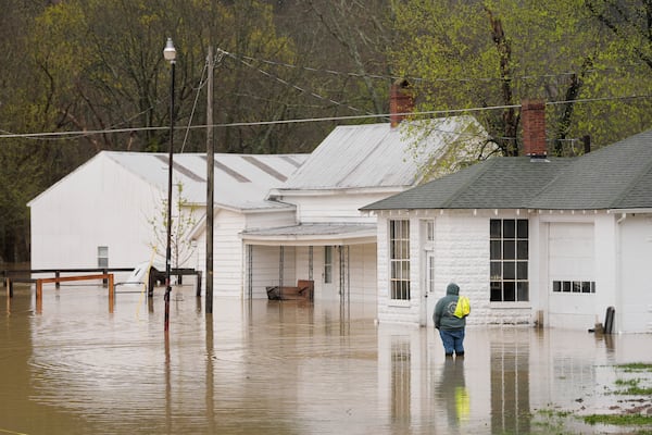 Abner Wagers stands near flooded homes in the rising waters of the Kentucky River in Monterey, Ky,. Sunday, April 6, 2025. (AP Photo/Carolyn Kaster)