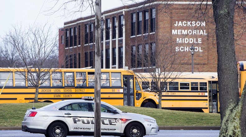 A police car is parked outside Jackson Township Middle School, Tuesday, Feb. 20, 2018 in Massillon, Ohio. A school official in Ohio says a middle school student apparently shot himself after bringing a gun to school. Police say Jackson Middle School, near Massillon, is on lockdown Tuesday and that the students and staff are safe.(Bob Rossiter/The Canton Repository via AP)