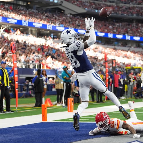 Dallas Cowboys wide receiver CeeDee Lamb (88) catches a touchdown pass as Kansas City Chiefs cornerback Trent McDuffie (22) defends during the first half of an NFL football game Thursday, Nov. 27, 2025, in Arlington, Texas. (AP Photo/Tony Gutierrez)