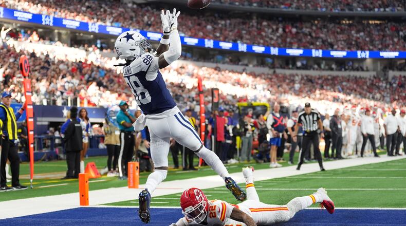 Dallas Cowboys wide receiver CeeDee Lamb (88) catches a touchdown pass as Kansas City Chiefs cornerback Trent McDuffie (22) defends during the first half of an NFL football game Thursday, Nov. 27, 2025, in Arlington, Texas. (AP Photo/Tony Gutierrez)