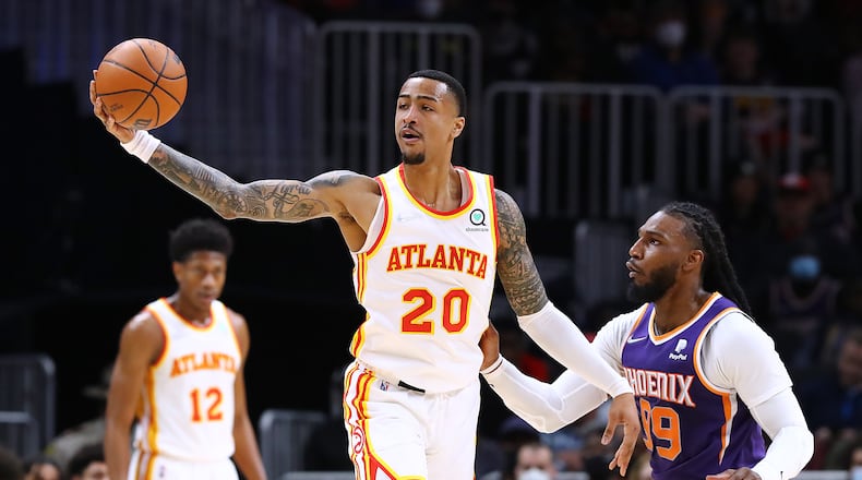 Hawks forward John Collins (20) is still recovering from a right foot strain. (Curtis Compton / Curtis.Compton@ajc.com)