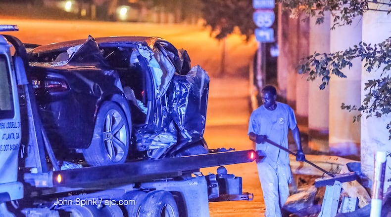 A car was removed from the scene of a fiery crash at Cheshire Bridge Road and I-85 in Atlanta. JOHN SPINK / JSPINK@AJC.COM