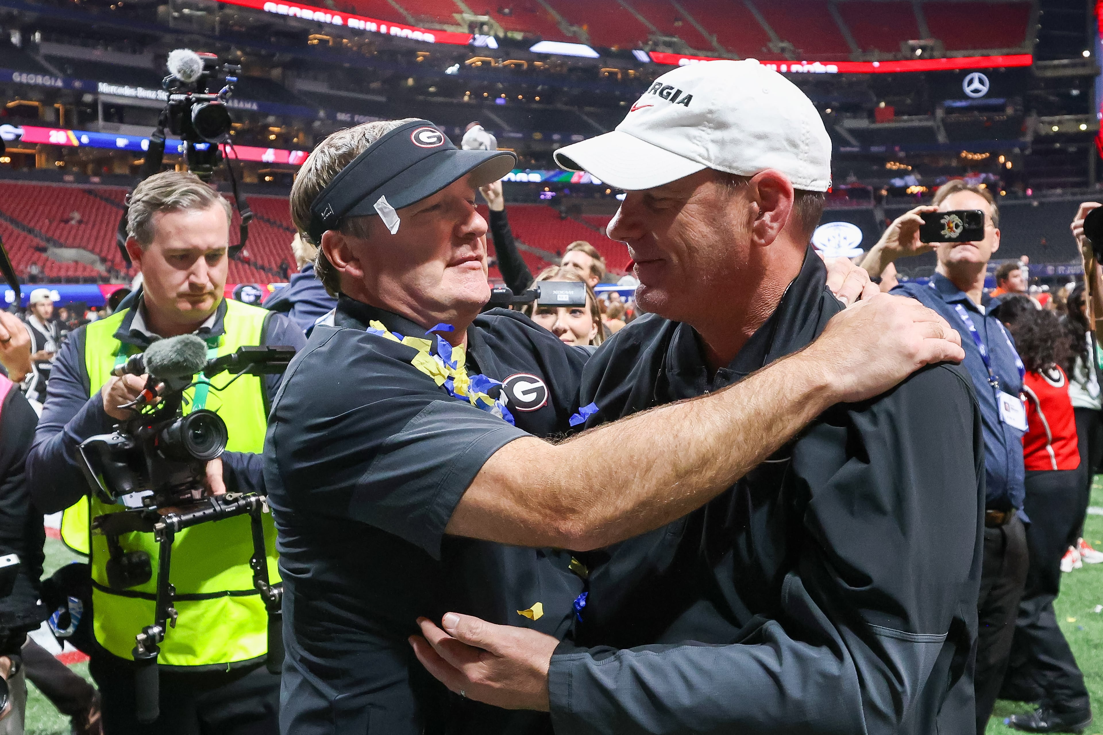 Georgia head coach Kirby Smart celebrates with offensive coordinator Mike Bobo after a 28-7 victory over Alabama in the SEC Championship game at Mercedes-Benz Stadium, Saturday, Dec. 6, 2025, in Atlanta. (Jason Getz / AJC)