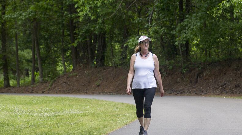 Duluth resident Debbie Proenza walks the trails at McDaniel Farm Park in Duluth, Monday, May 7, 2018. Debbie has lived in Duluth for more than 10 years and says she enjoys living near the park. ALYSSA POINTER/ALYSSA.POINTER@AJC.COM
